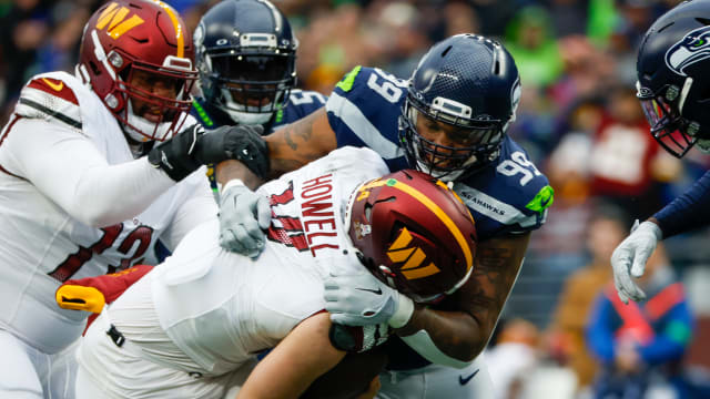 Seattle Seahawks defensive end Leonard Williams (99) sacks Washington Commanders quarterback Sam Howell (14) during the second quarter at Lumen Field.